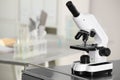 Modern medical microscope on metal table in laboratory, space for text Royalty Free Stock Photo