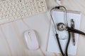 Modern medical office working with computer keyboard on stethoscope over notebook Royalty Free Stock Photo