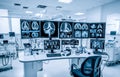 Modern medical research lab with multiple computer screens displaying brain scans, equipment for analysis in bright workspace, Royalty Free Stock Photo