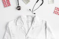 Modern medicine workplace with overall, meds and stethoscope white table flat lay space for text Royalty Free Stock Photo