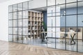 Modern meeting room interior with glass partition, wooden flooring and bookcase. Royalty Free Stock Photo