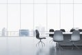 Modern meeting room interior with reflections on concrete flooring and panoramic window with city view and daylight. Commercial Royalty Free Stock Photo