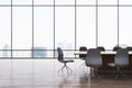 Modern meeting room interior with reflections on wooden flooring and panoramic window with city view and daylight. Commercial Royalty Free Stock Photo