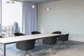 Modern meeting room office interior with table, armchairs, window with city view, curtains and mock up place on wall. Royalty Free Stock Photo