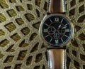 Modern men`s watch, brown-gold color in close up shot