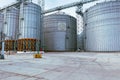 Modern metal grain elevator in agricultural zone. Storage of grain and other different cereals. Sunflower oil factory. Royalty Free Stock Photo