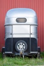 Modern metal horse trailer with spare wheel on the green grass Royalty Free Stock Photo