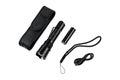 Modern metal LED flashlight in black color. Portable flashlight isolate on a white back