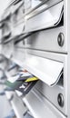 Modern metal mail boxes, full of leaflets