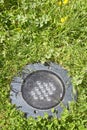 Modern metal spotlight led lamp for outdoor use of circular shape recessed in a grass area