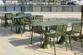 Modern metal tables and chairs are khaki color. Empty outdoor cafÃ©. Urban street furniture Royalty Free Stock Photo