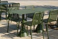 Modern metal tables and chairs are khaki color. Empty outdoor cafe. Urban street furniture Royalty Free Stock Photo