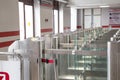 Modern metallic turnstile gate, entrance of railway station. Moscow, Russia