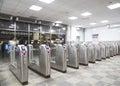 Modern metallic turnstile gate, entrance of railway station. Moscow, Russia