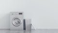 Modern metallic washing machine, laundry in baskets and domestic emty room interior. Blue wall