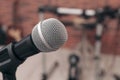 Modern microphone on blurred background, closeup. Space for text Royalty Free Stock Photo