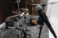 Modern microphone at recording studio, space for text. Music band practice Royalty Free Stock Photo