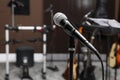 Modern microphone at recording studio, space for text. Music band practice Royalty Free Stock Photo