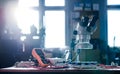 Modern microscope, connectors component and large green microcircuit in workshop laboratory Royalty Free Stock Photo
