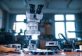 Modern microscope, connectors component and large green microcircuit in workshop laboratory Royalty Free Stock Photo