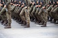 Modern military footwear on soldiers. A soldier in uniform is marching in the parade. People in the crowd. Boots on the