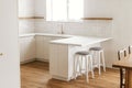Modern minimal kitchen design. Modern kitchen interior. Stylish white kitchen cabinets with brass knobs, faucet, granite island, Royalty Free Stock Photo