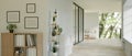 A modern minimal white building corridor interior with bookcases, a cactus shelf, and the white wall