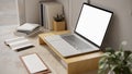 Modern minimal working space with laptop mockup on wooden laptop stand on the table