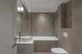 Modern minimalist bathroom beige interior design with marble tiles and beige furniture.