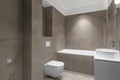 Modern minimalist bathroom beige interior design with marble tiles and beige furniture.