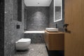 Modern minimalist bathroom dark interior design with dark stone tiles and wood furniture Royalty Free Stock Photo