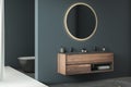 Modern minimalist bathroom interior, modern bathroom cabinet, double sink, oval mirror, concrete flooring, Royalty Free Stock Photo