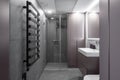 Modern minimalist bathroom interior design with grey stone tiles. Royalty Free Stock Photo