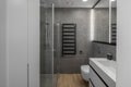 Modern minimalist bathroom interior design with grey stone tiles. Royalty Free Stock Photo