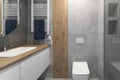 Modern minimalist bathroom interior design with grey stone tiles and wood wall texture. Royalty Free Stock Photo