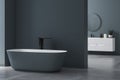 Modern minimalist bathroom interior, modern bathroom cabinet, white sink, oval mirror, concrete flooring, Royalty Free Stock Photo