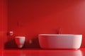 Modern minimalist bathroom interior with red walls and white fixtures Royalty Free Stock Photo