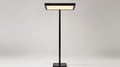 Modern Minimalist Black Floor Lamp with Rectangular Shade Illuminating a Clean White Background for Contemporary Royalty Free Stock Photo