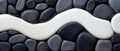 Modern Minimalist Design with Black and White Pebbles on a Smooth Surface Royalty Free Stock Photo