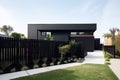 modern, minimalist house exterior with minimalist garden and sleek black fence