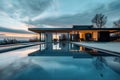 Modern minimalist house with infinity pool at sunrise. Architectural photography with scenic view and reflection. Luxury Royalty Free Stock Photo