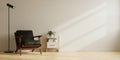 Modern minimalist interior with a black leather armchair on empty white wall background Royalty Free Stock Photo