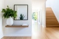 Modern minimalist interior design with wooden stairs and greenery decor Royalty Free Stock Photo