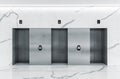 Modern minimalist lobby interior with three steel lift doors