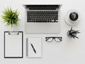 Modern minimalist office desk setup with laptop coffee plant and notebook Royalty Free Stock Photo