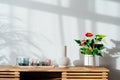 Modern minimalist Scandinavian style interior. Candles, ceramic vase and House plant red Anthurium in a pot on a wooden Royalty Free Stock Photo