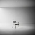 Modern minimalist scene featuring a single, gray upholstered chair with a sleek frame Royalty Free Stock Photo