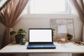 Modern minimalist workplace with laptop mockup with white empty screen on wooden desk with mood board with pined notes and photo, Royalty Free Stock Photo