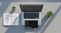 Modern minimalist workspace with open laptop displaying programming code, notebook with flowchart, pen, and small succulent plant Royalty Free Stock Photo