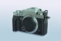 Modern mirrorless digital camera in retro style close-up, black, metal, body without a lens on an isolated white background,